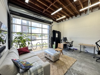 Interior of a small bay flex space with open garage door — Fort Lauderdale commercial real estate