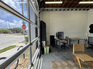 Interior of a small bay flex space with open garage door — Fort Lauderdale commercial real estate