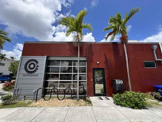Interior of a small bay flex space with open garage door — Fort Lauderdale commercial real estate